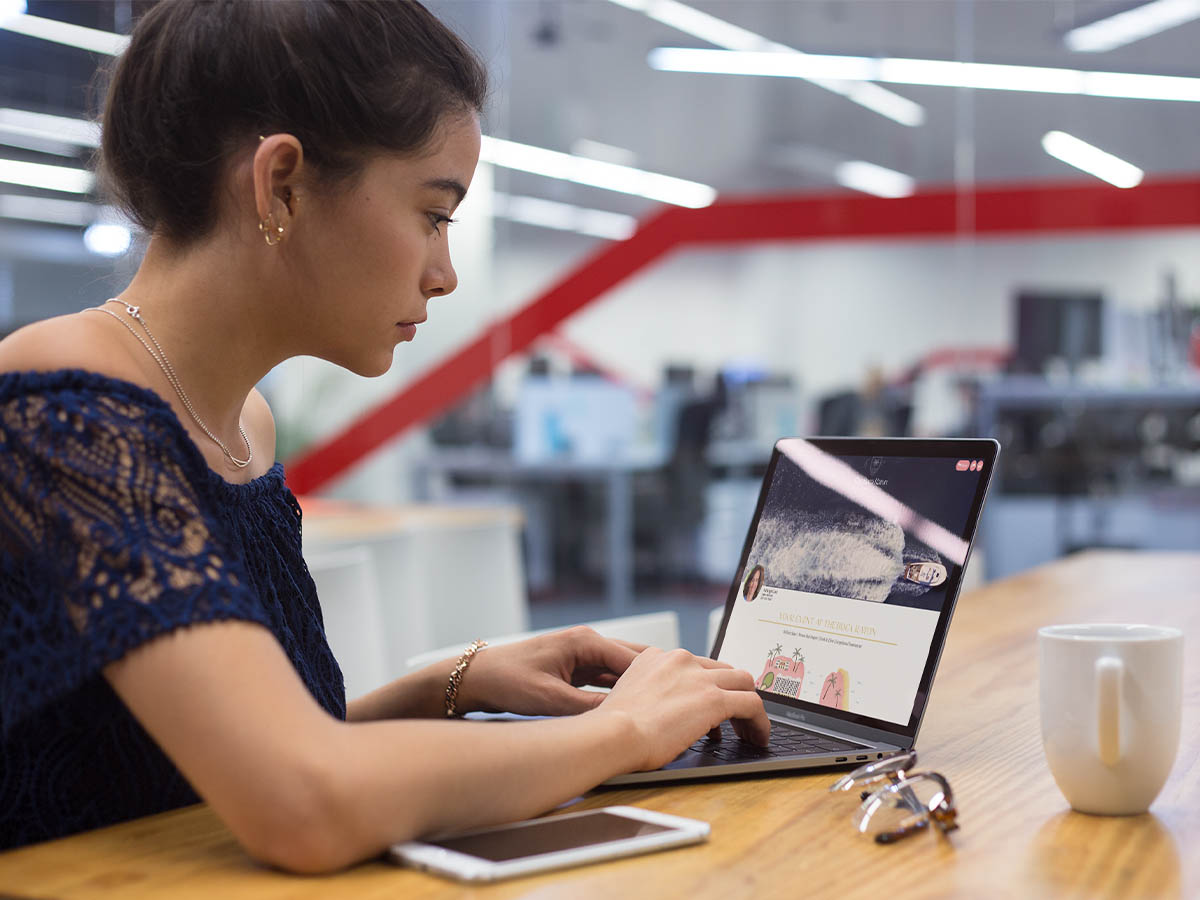 pics-_0001_mockup-of-a-girl-working-with-a-macbook-on-a-wooden-desk-a21446